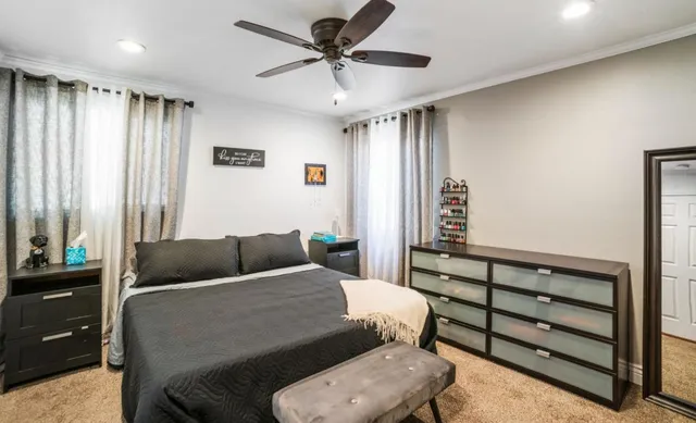 a bedroom with a bed and a chandelier