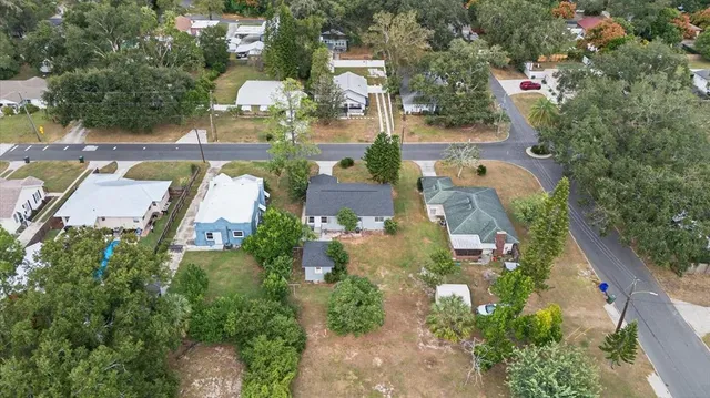 an aerial view of multiple houses with yard