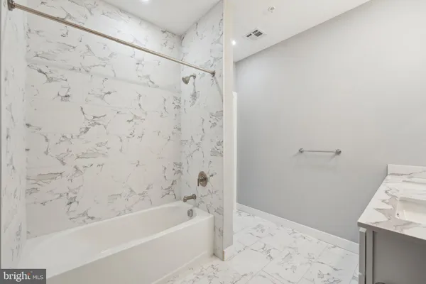 a bathroom with a bathtub and shower