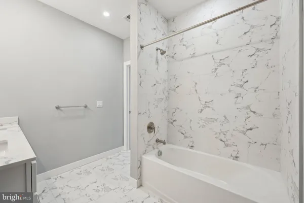 a bathroom with a bathtub and shower