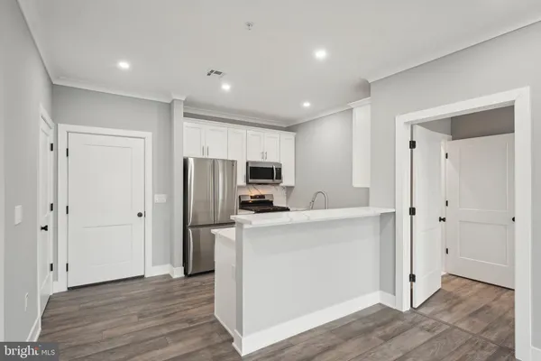 a view of kitchen with stainless steel appliances refrigerator oven and microwave