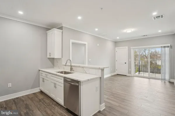 a view of a kitchen counter space with wooden floor
