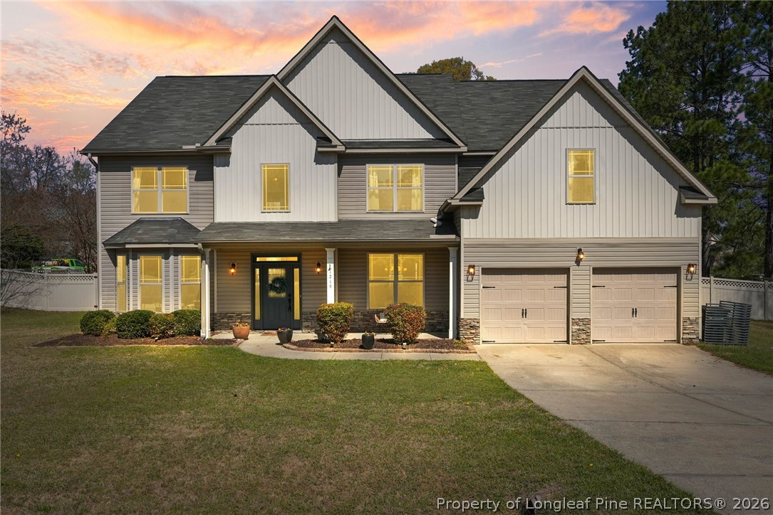 1219 Coachman Way Sanford, NC 27332 - Photo 1 of 46 a front view of a house with a yard