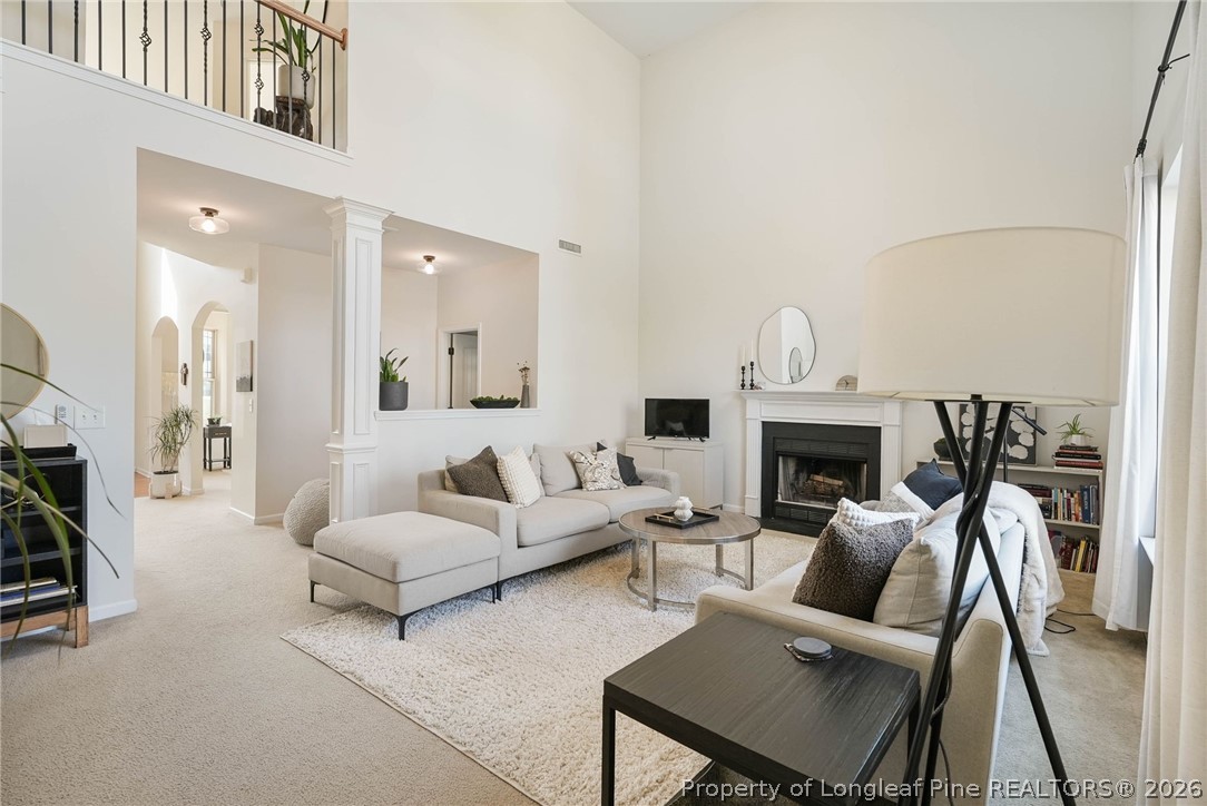 1219 Coachman Way Sanford, NC 27332 - Photo 11 of 46 a living room with furniture a fireplace and a flat screen tv