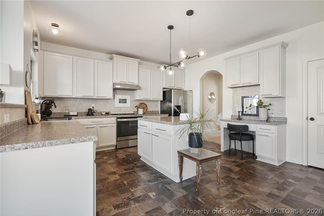 1219 Coachman Way Sanford, NC 27332 - Photo 16 of 46 a kitchen with white cabinets and appliances