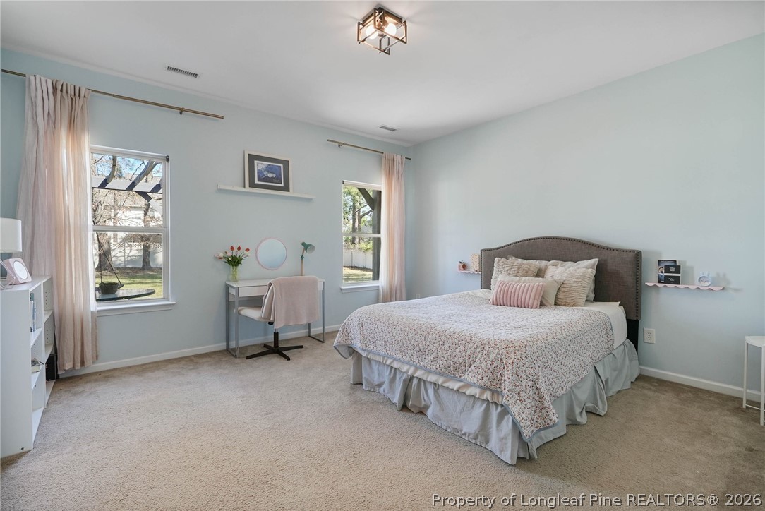 1219 Coachman Way Sanford, NC 27332 - Photo 19 of 46 a bedroom with a bed and a window