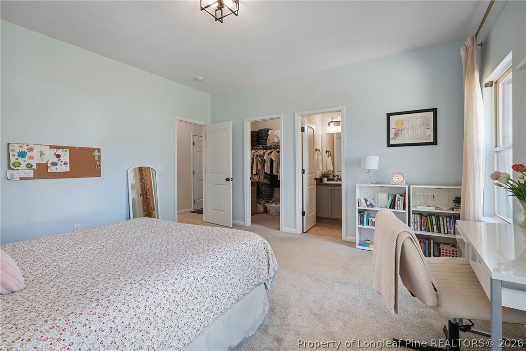 1219 Coachman Way Sanford, NC 27332 - Photo 20 of 46 a large bedroom with a bed and furniture