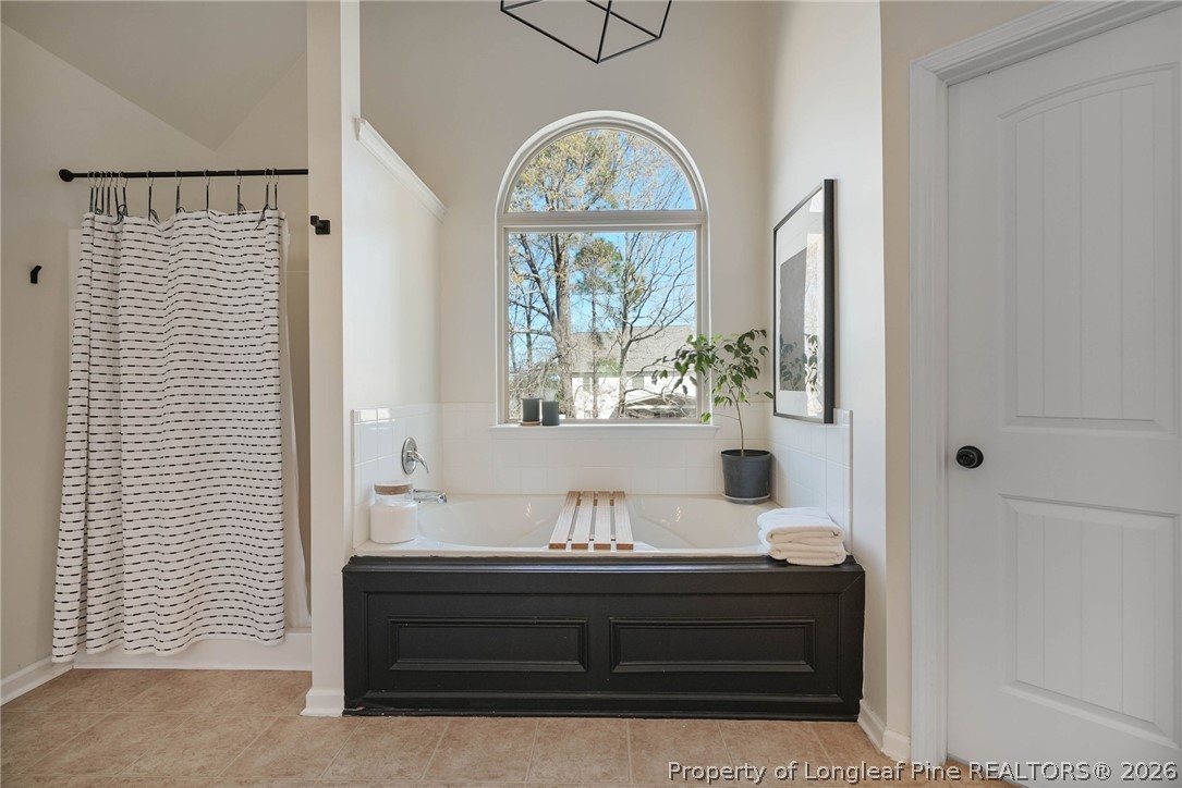 1219 Coachman Way Sanford, NC 27332 - Photo 26 of 46 a view of spacious bedroom with a large window and chandelier