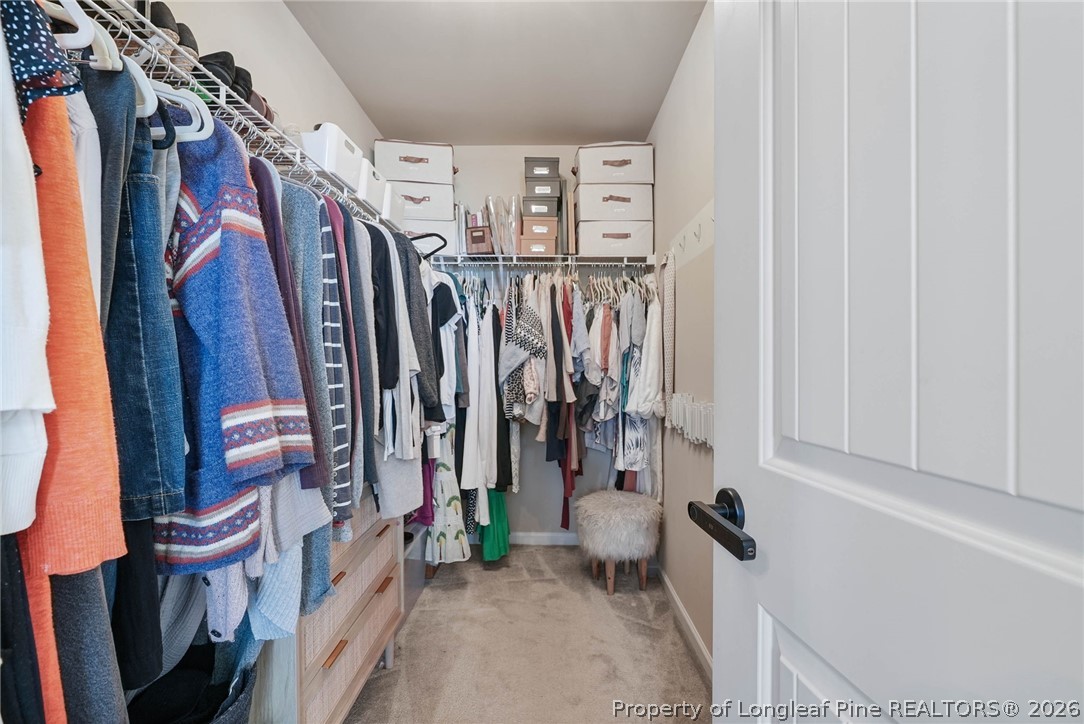 1219 Coachman Way Sanford, NC 27332 - Photo 30 of 46 a view of walk in closet with clothes