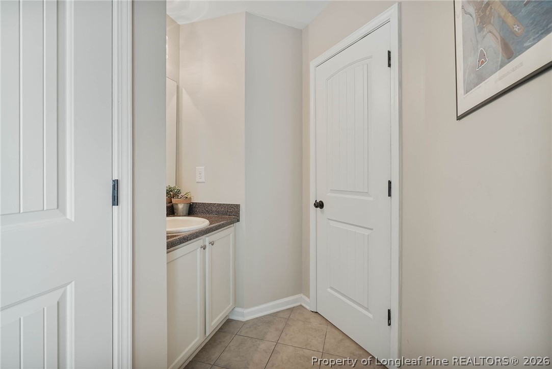 1219 Coachman Way Sanford, NC 27332 - Photo 31 of 46 a bathroom with a sink and mirror