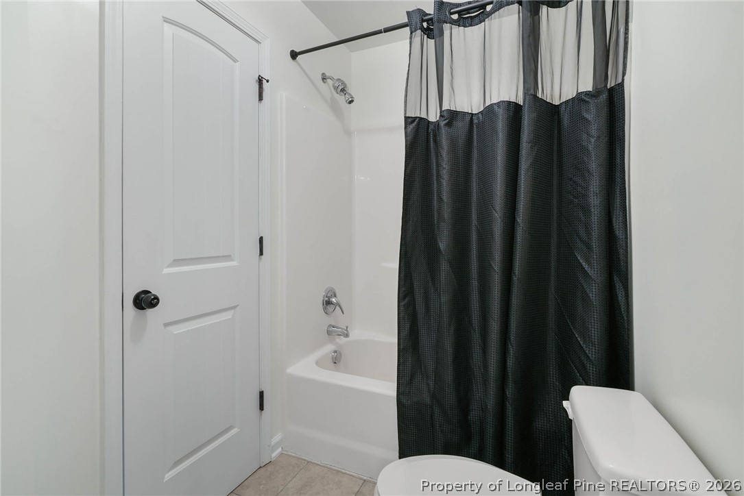 1219 Coachman Way Sanford, NC 27332 - Photo 32 of 46 a bathroom with a shower a toilet and bathtub