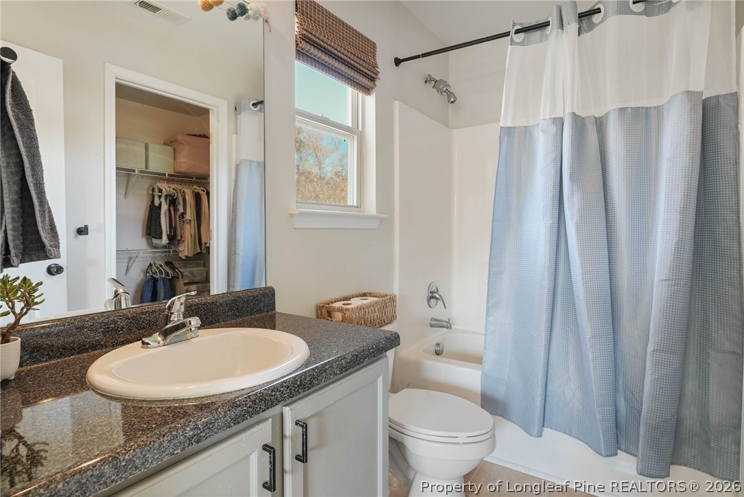 1219 Coachman Way Sanford, NC 27332 - Photo 36 of 46 a bathroom with a granite countertop sink and a mirror