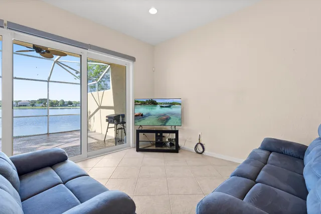 a bedroom with a bed and a flat tv screen on dresser