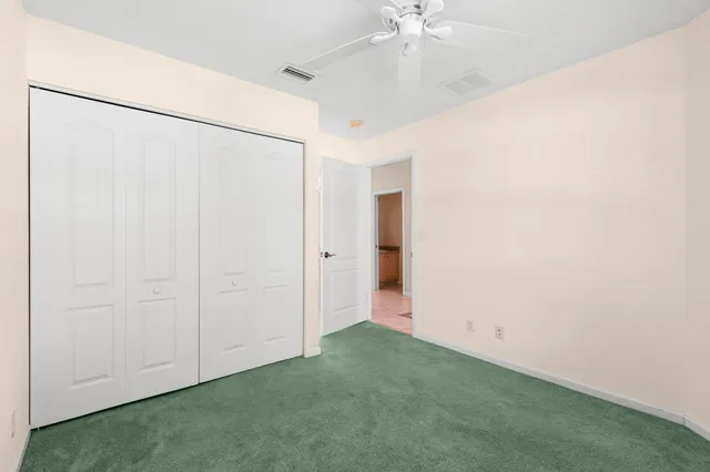 a view of a swimming pool with a chair and tables in the patio