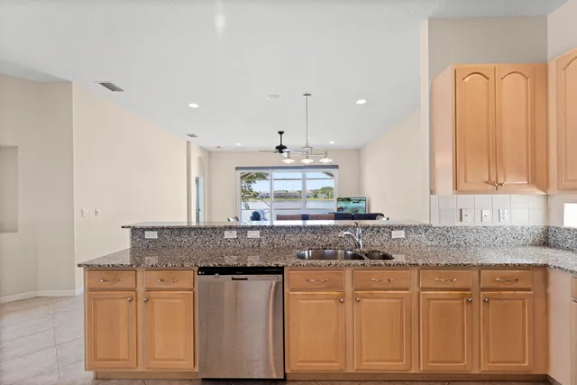a view of a dining room with furniture and a chandelier