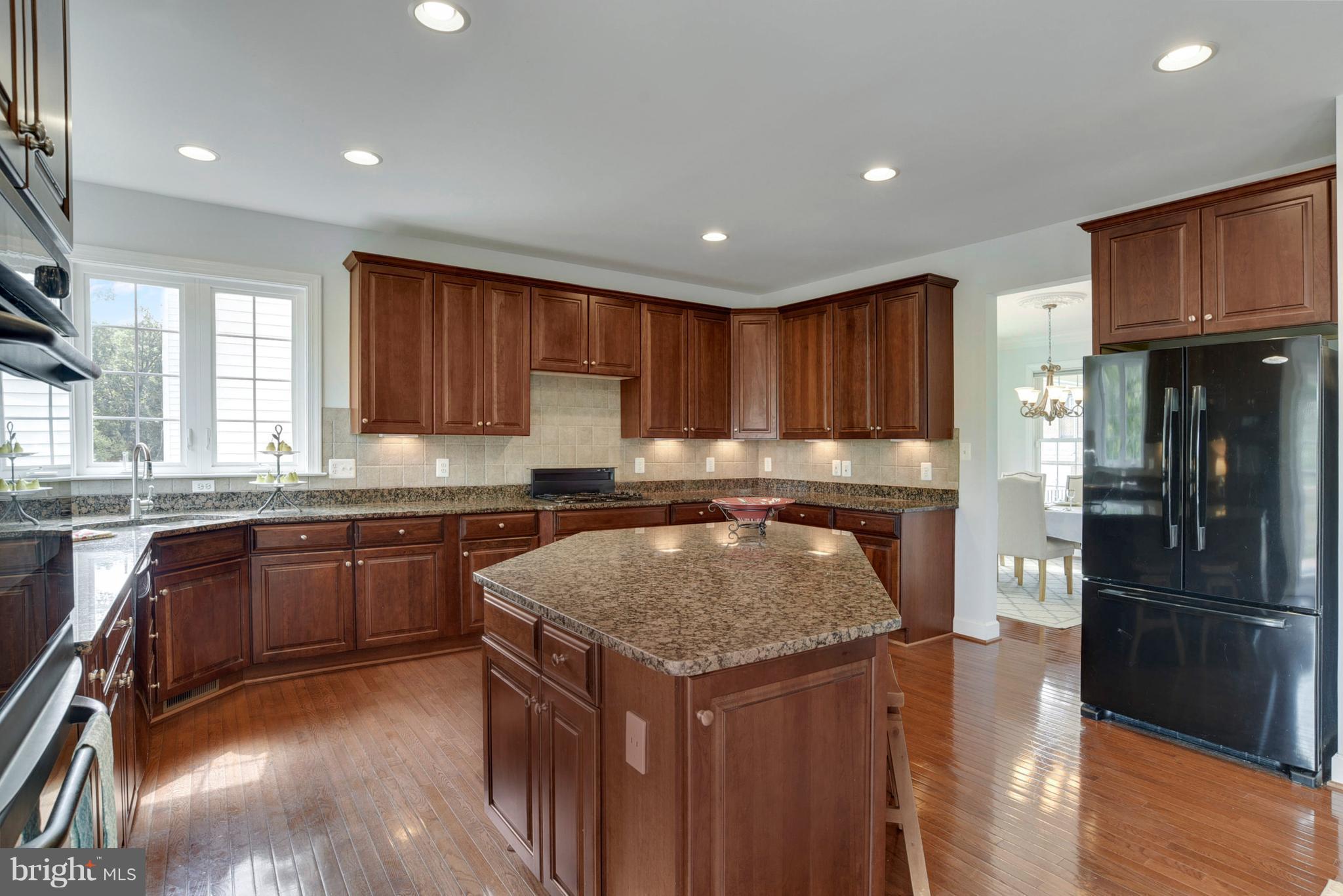 14554 Old Mill Road Centreville, VA 20121 - Photo 6 of 27 Expansive granite countertops and wood floors