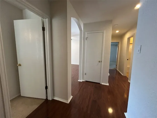 a view of a hallway with wooden floor