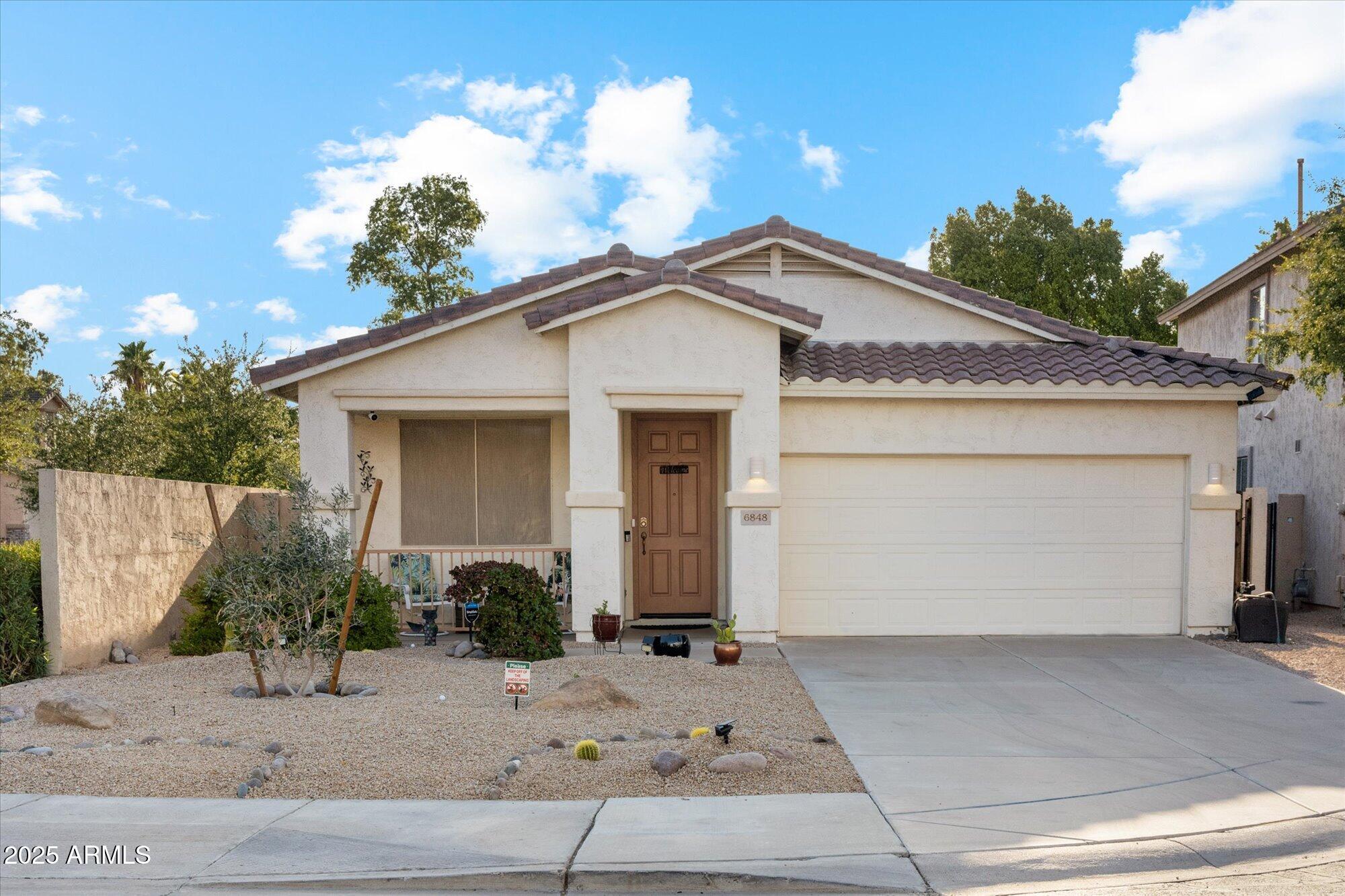 6848 South 27th Street Phoenix, AZ 85042 - Photo 1 of 28 a front view of a house with a yard and garage