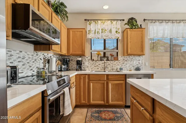 a kitchen with stainless steel appliances a sink stove and cabinets