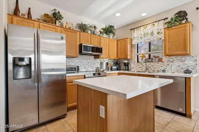 a kitchen with stainless steel appliances granite countertop a refrigerator a sink and a refrigerator