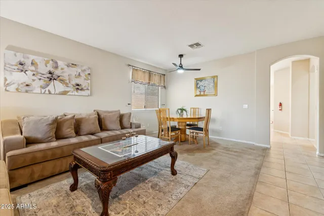a living room with furniture a rug and a window