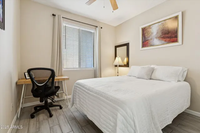 a bedroom with a bed and a desk