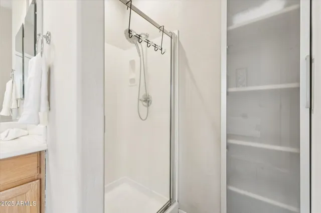 a bathroom with a glass shower door