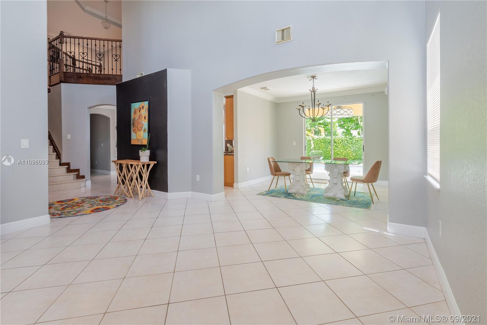 12171 Southwest 122nd Path Miami, FL 33186 - Photo 2 of 16 a living room with furniture and a chandelier