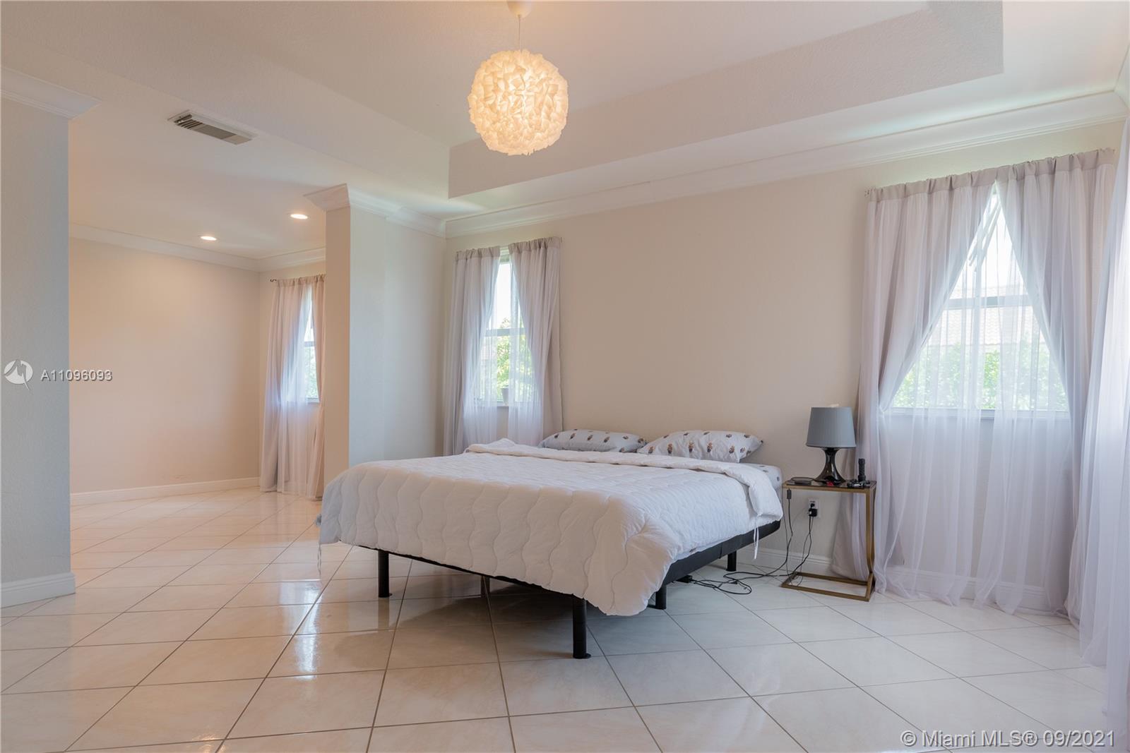 12171 Southwest 122nd Path Miami, FL 33186 - Photo 11 of 16 a bedroom with a bed and a window