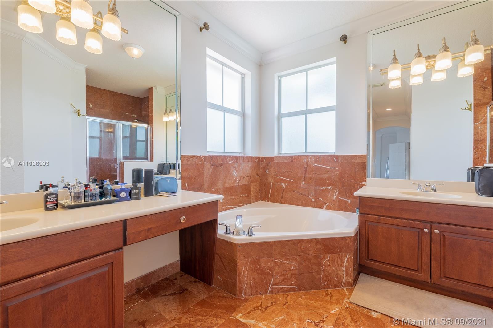 12171 Southwest 122nd Path Miami, FL 33186 - Photo 12 of 16 a bathroom with a tub sink and mirror