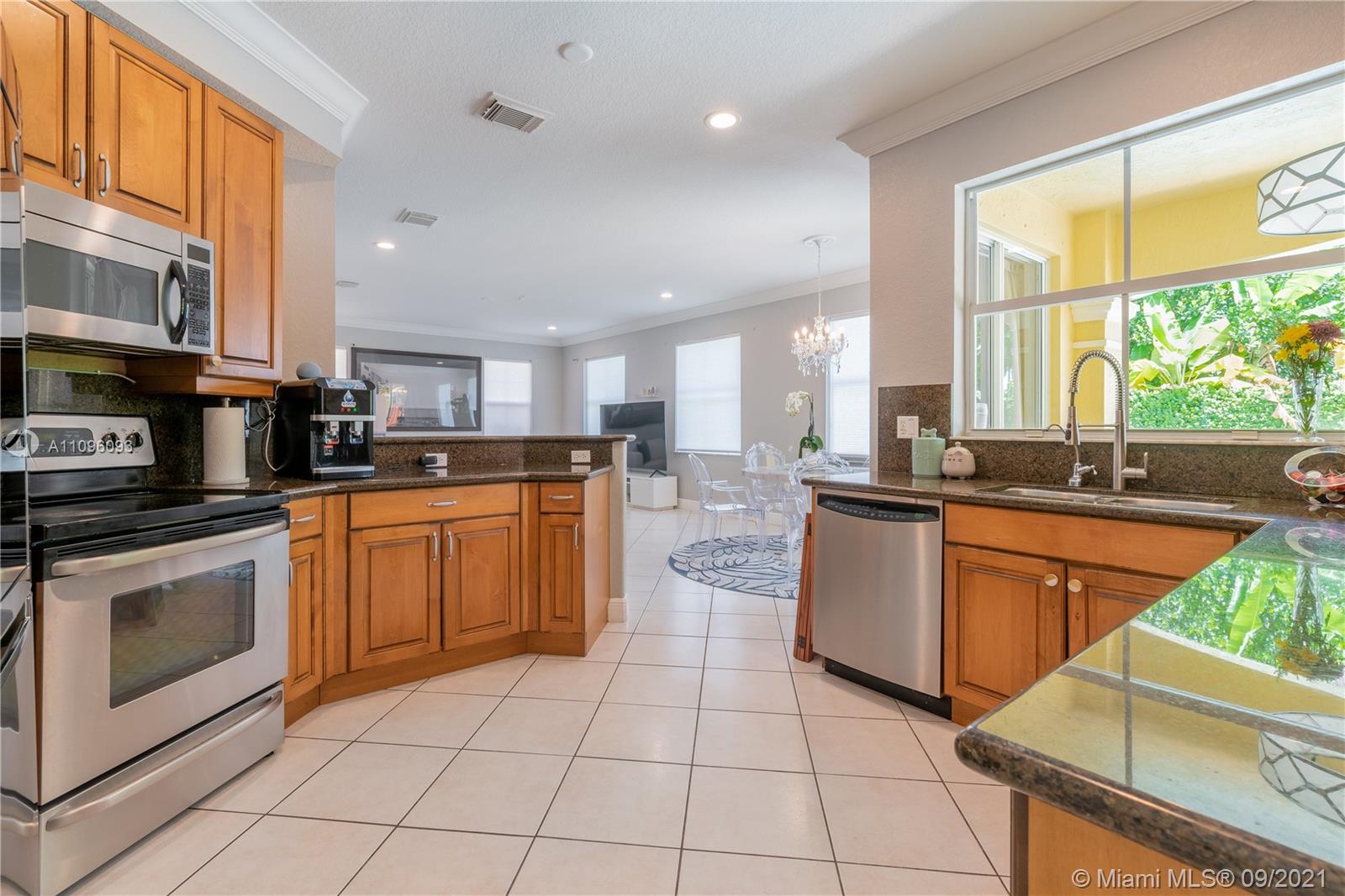 12171 Southwest 122nd Path Miami, FL 33186 - Photo 5 of 16 a kitchen with stainless steel appliances granite countertop a stove a sink and a microwave