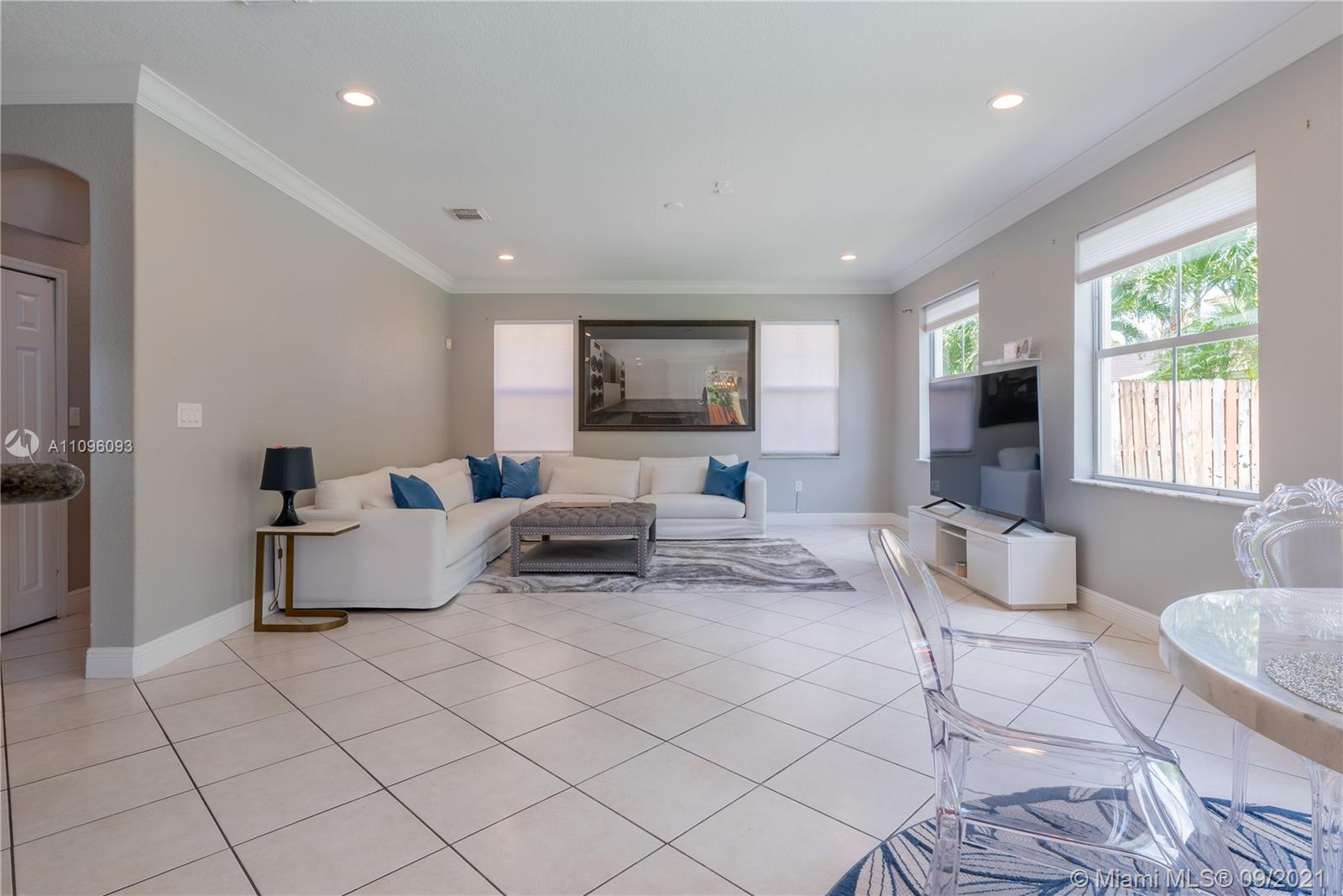 12171 Southwest 122nd Path Miami, FL 33186 - Photo 6 of 16 a living room with furniture and a flat screen tv