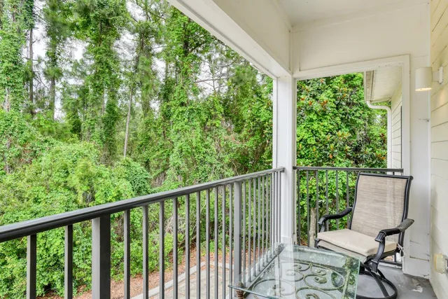 a view of a balcony with chairs