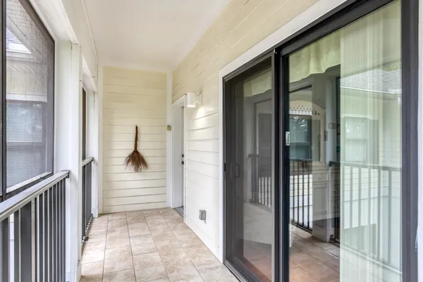 a view of a hallway with white walls and door