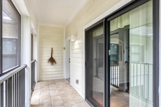 a view of a hallway with white walls and door