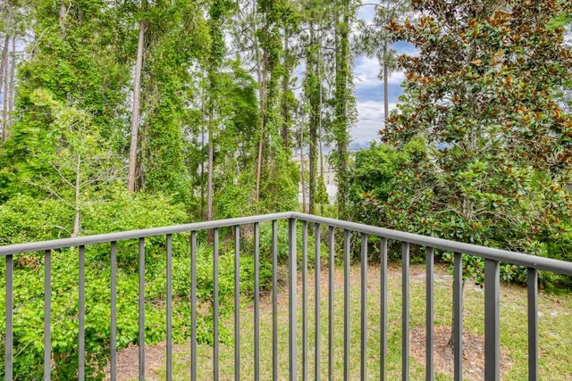 a view of a balcony with a tree