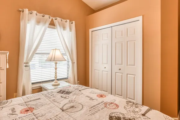 a bedroom with a bed and a window