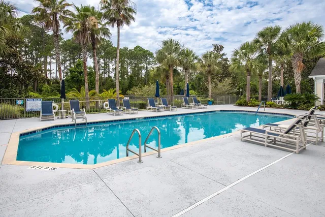 a view of a swimming pool with outdoor seating