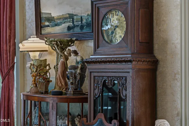 a living room with furniture a chandelier and a fireplace