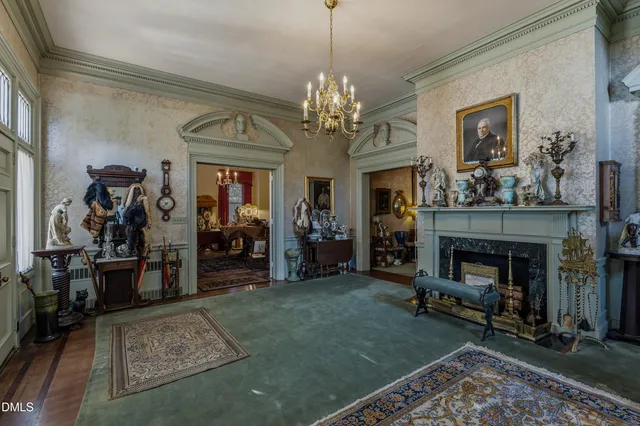 a living room with lots of furniture and a chandelier