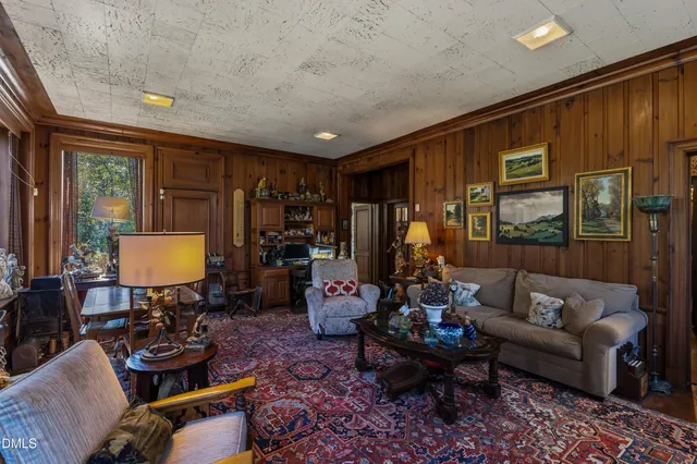 a view of a pathway with flower plants and wooden fence