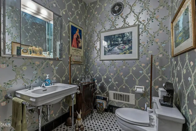 a view of a patio with table and chairs potted plants and large tree