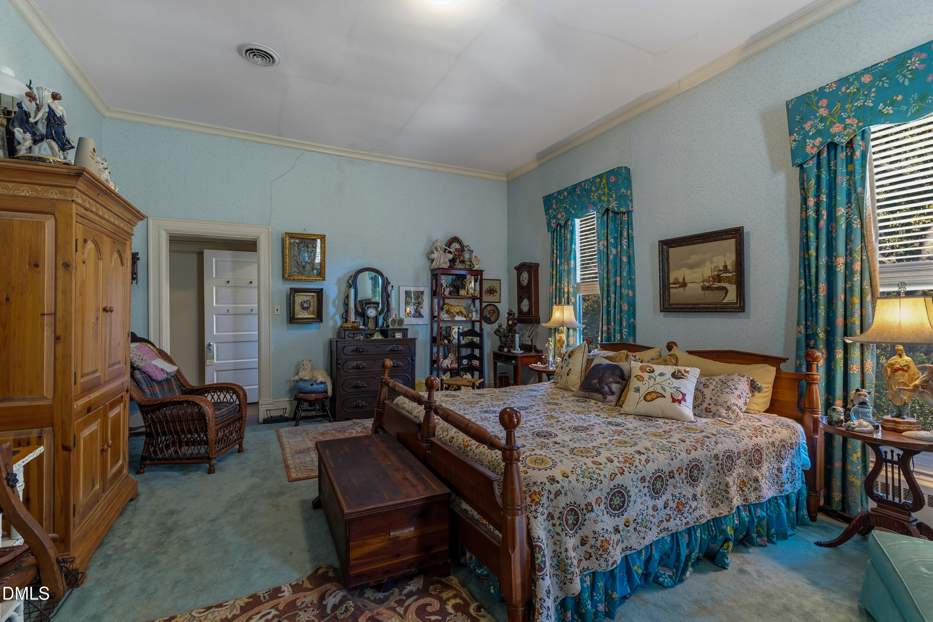 900 Nash Street North Wilson, NC 27893 - Photo 50 of 99 a bedroom with a bed a mirror and dresser