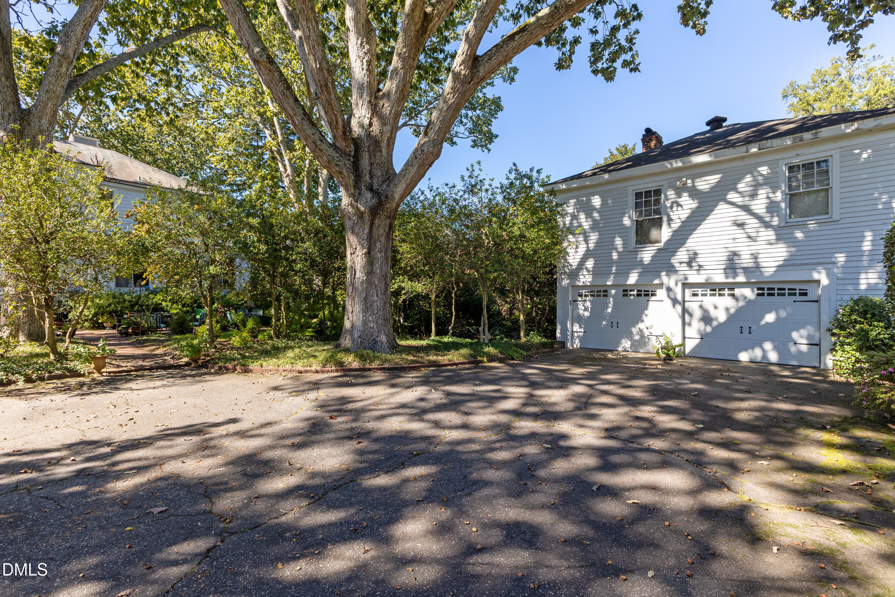 900 Nash Street North Wilson, NC 27893 - Photo 80 of 99 a backyard of a house with large trees and outdoor seating