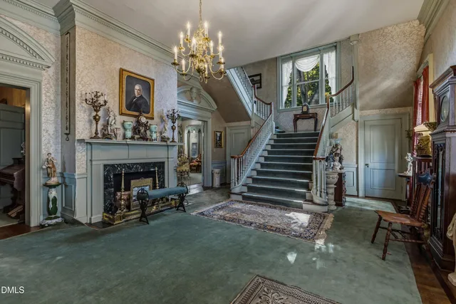 a view of a dining room with furniture and chandelier