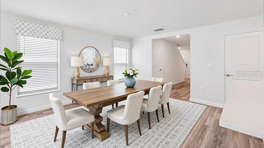 10562 Tucker Road Weeki Wachee, FL 34613 - Photo 3 of 16 a view of a dining room with furniture and a potted plant