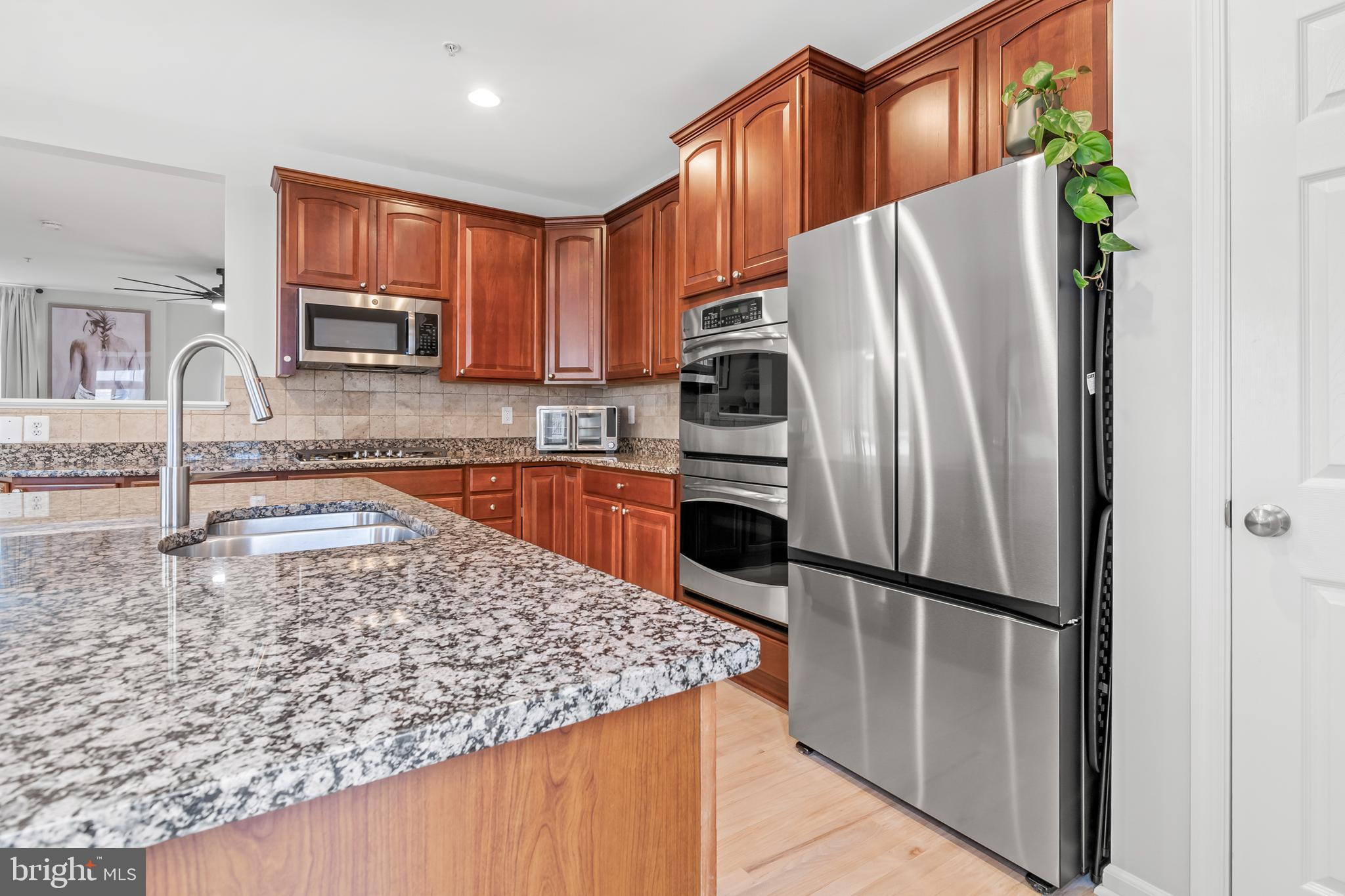 1750 Theale Way Hanover, MD 21076 - Photo 11 of 42 a kitchen with granite countertop a refrigerator and a sink