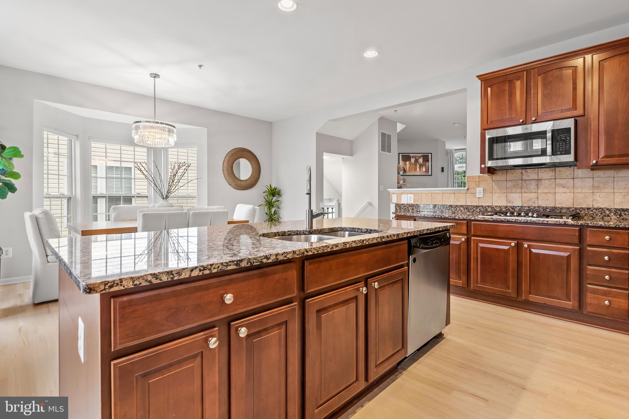 1750 Theale Way Hanover, MD 21076 - Photo 13 of 42 a kitchen with granite countertop stainless steel appliances a stove sink and cabinets