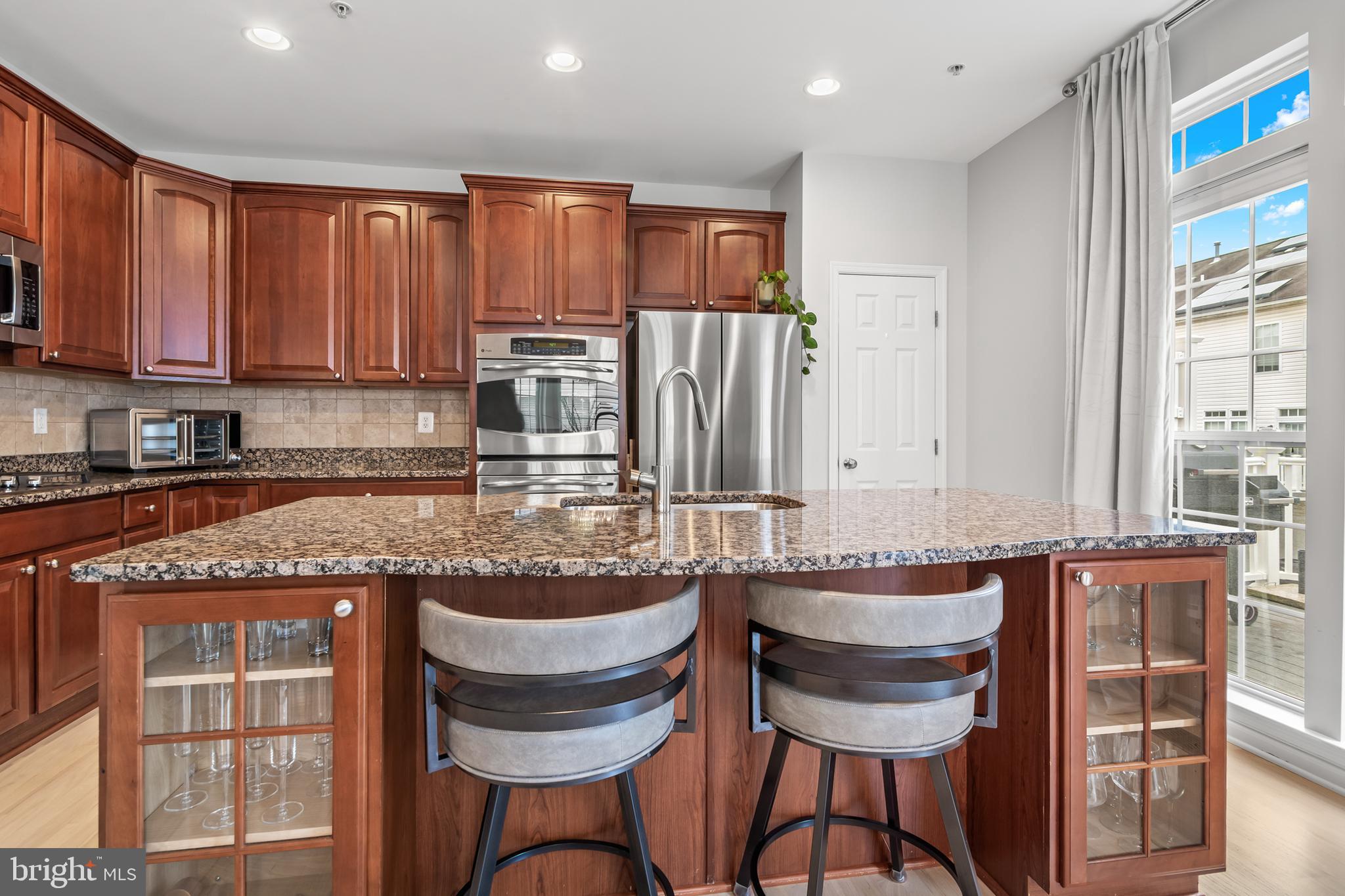 1750 Theale Way Hanover, MD 21076 - Photo 17 of 42 a kitchen with granite countertop a sink and cabinets