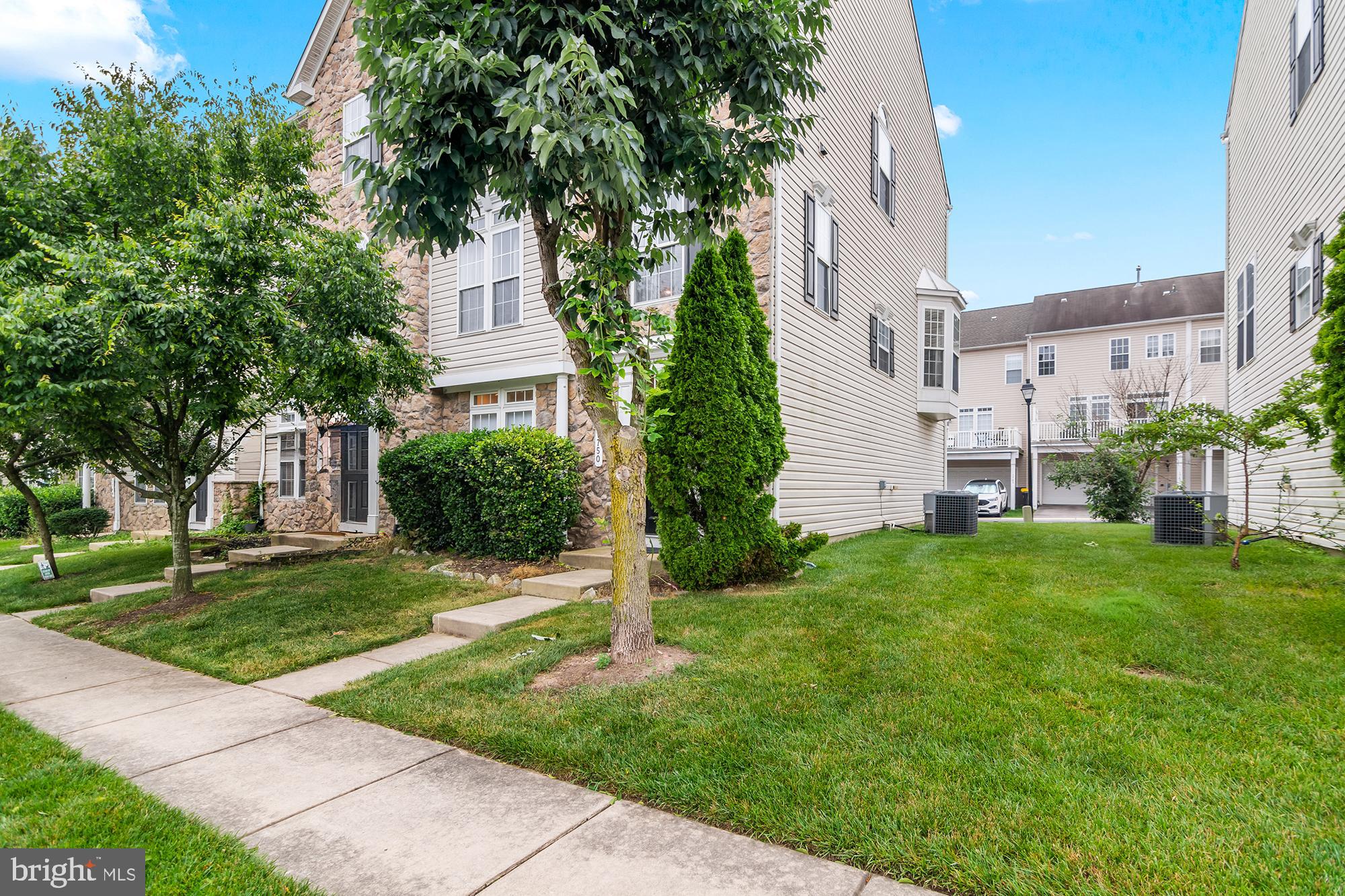 1750 Theale Way Hanover, MD 21076 - Photo 2 of 42 a view of a brick house with a big yard plants and a large tree